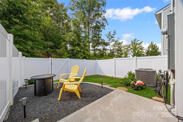 a backyard of a house with table and chairs