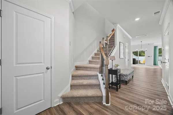 a view of entryway and hall with wooden floor