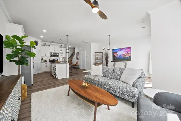 a living room with furniture and a chandelier