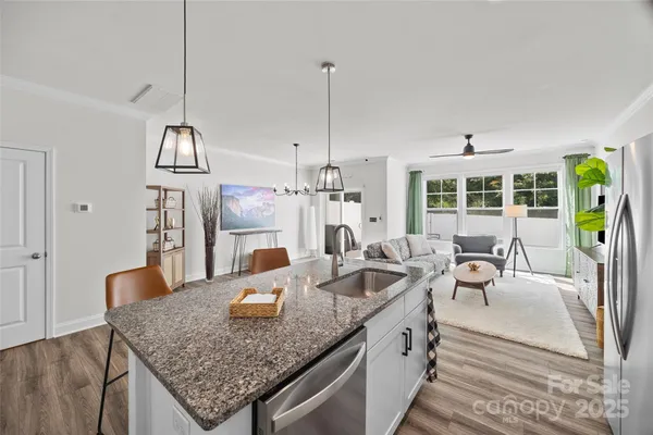 a kitchen with center island table and chairs