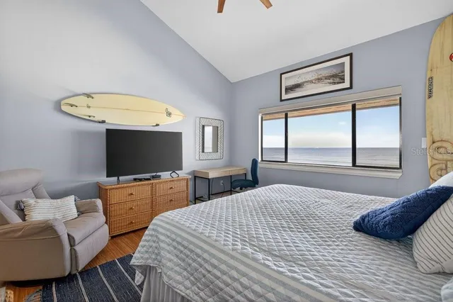 a bedroom with a bed and a flat screen tv