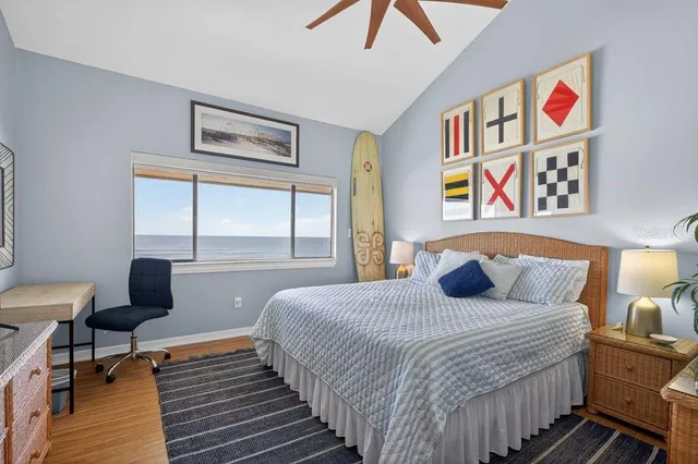 a bedroom with a bed and a painting on the wall