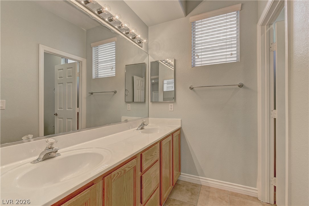 1813 Snow Spring Lane Las Vegas, NV 89134 - Photo 31 of 37 Double vanity with ample counter space and well-lit mirror offers practical elegance.