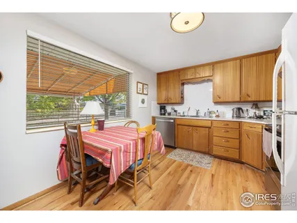 a kitchen with a stove a table and chairs