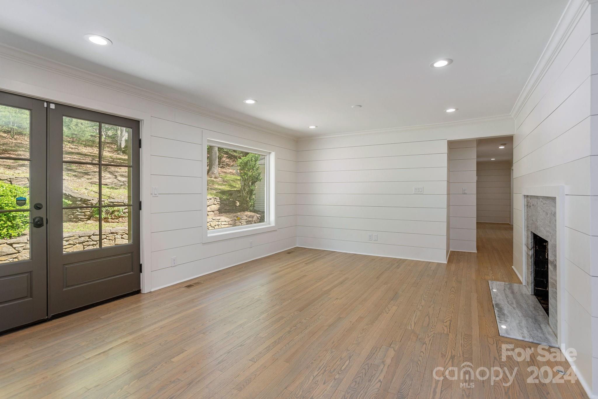 51 Forest Road Asheville, NC 28803 - Photo 17 of 45 an empty room with wooden floor and windows