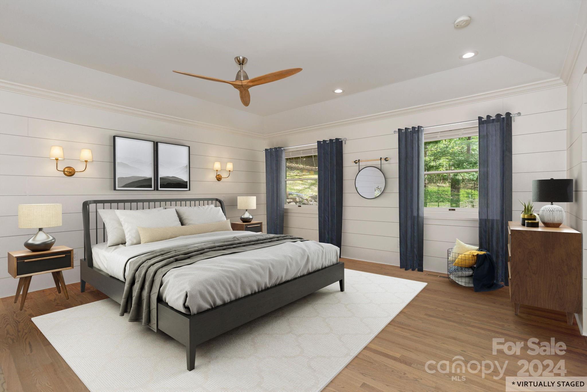 51 Forest Road Asheville, NC 28803 - Photo 20 of 45 a bedroom with a large bed and a chandelier