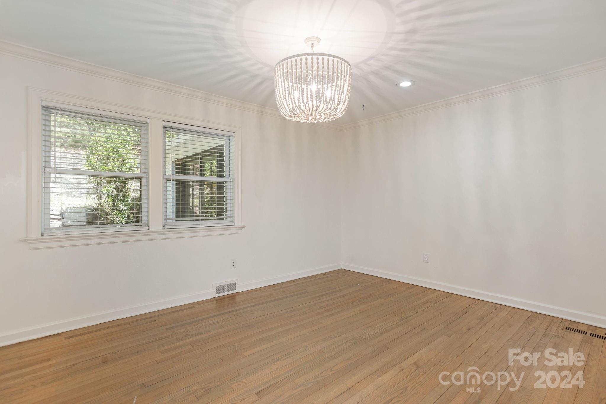 51 Forest Road Asheville, NC 28803 - Photo 28 of 45 an empty room with wooden floor and windows
