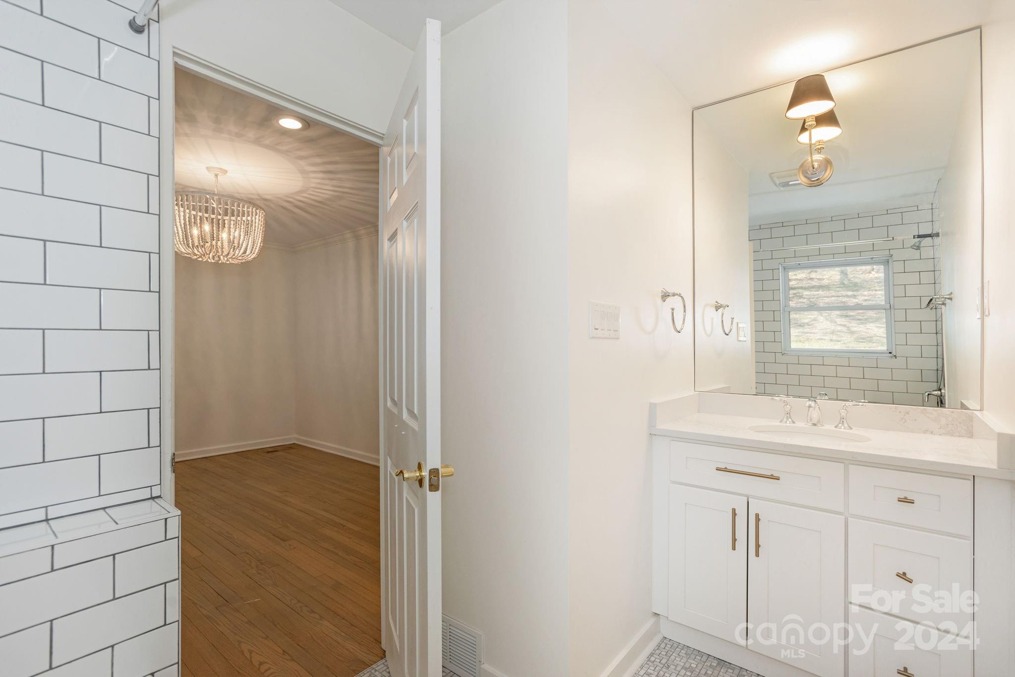51 Forest Road Asheville, NC 28803 - Photo 29 of 45 a bathroom with a sink shower and a mirror