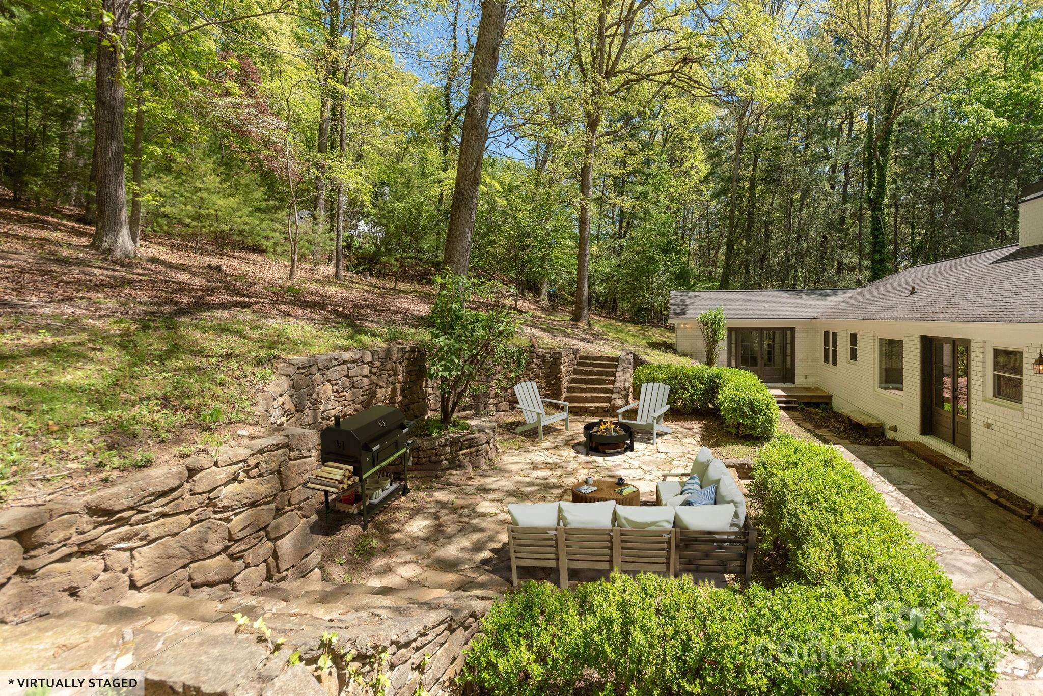 51 Forest Road Asheville, NC 28803 - Photo 39 of 45 a view of a house with backyard sitting area and garden