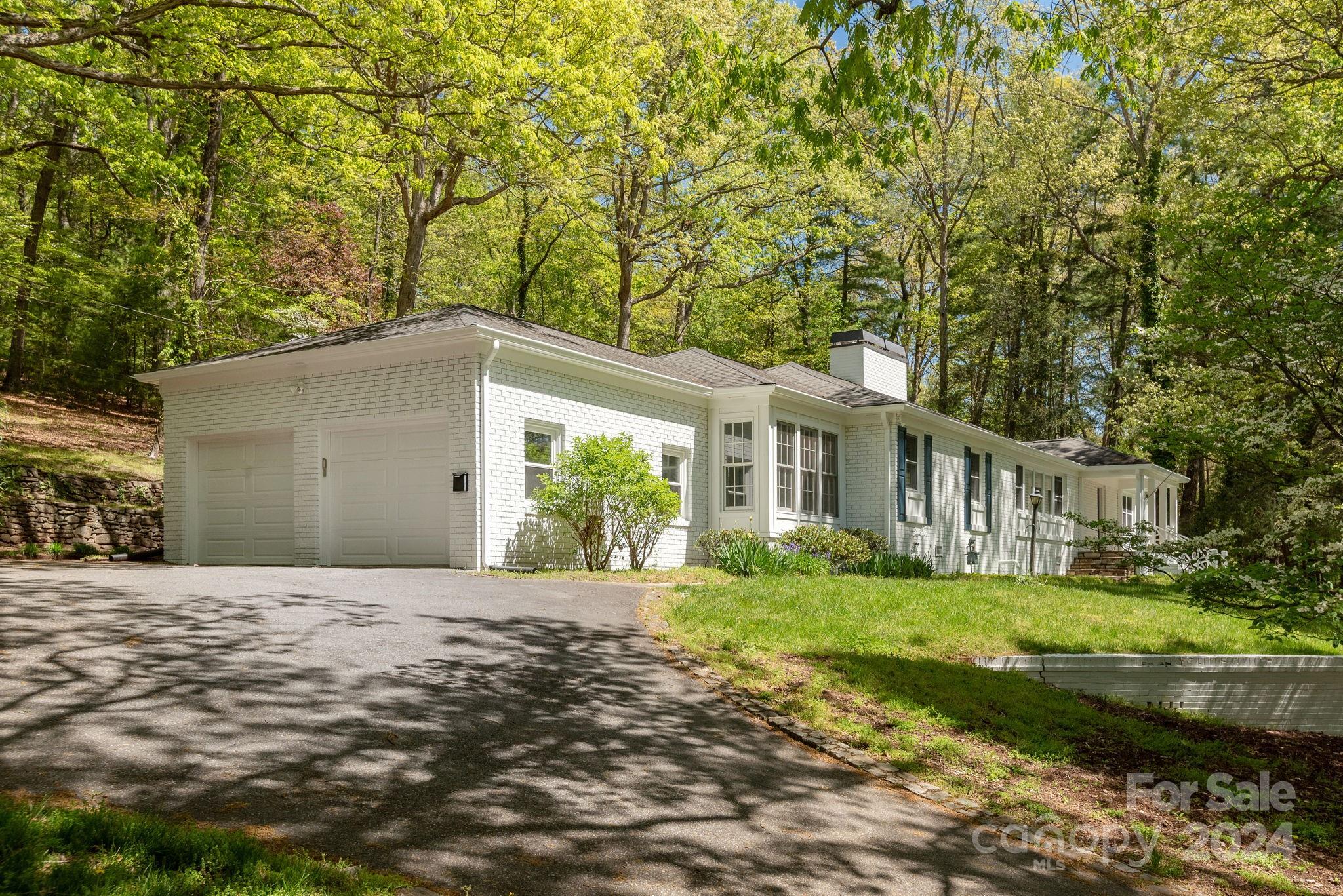 51 Forest Road Asheville, NC 28803 - Photo 42 of 45 a front view of a house with a yard and potted plants