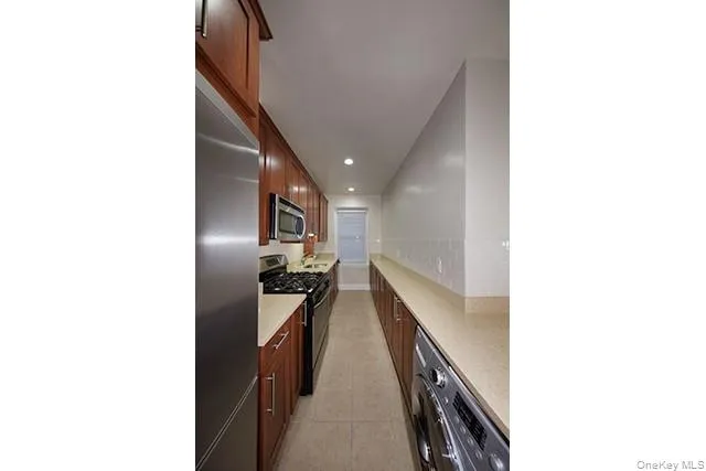 a hallway with furniture and kitchen