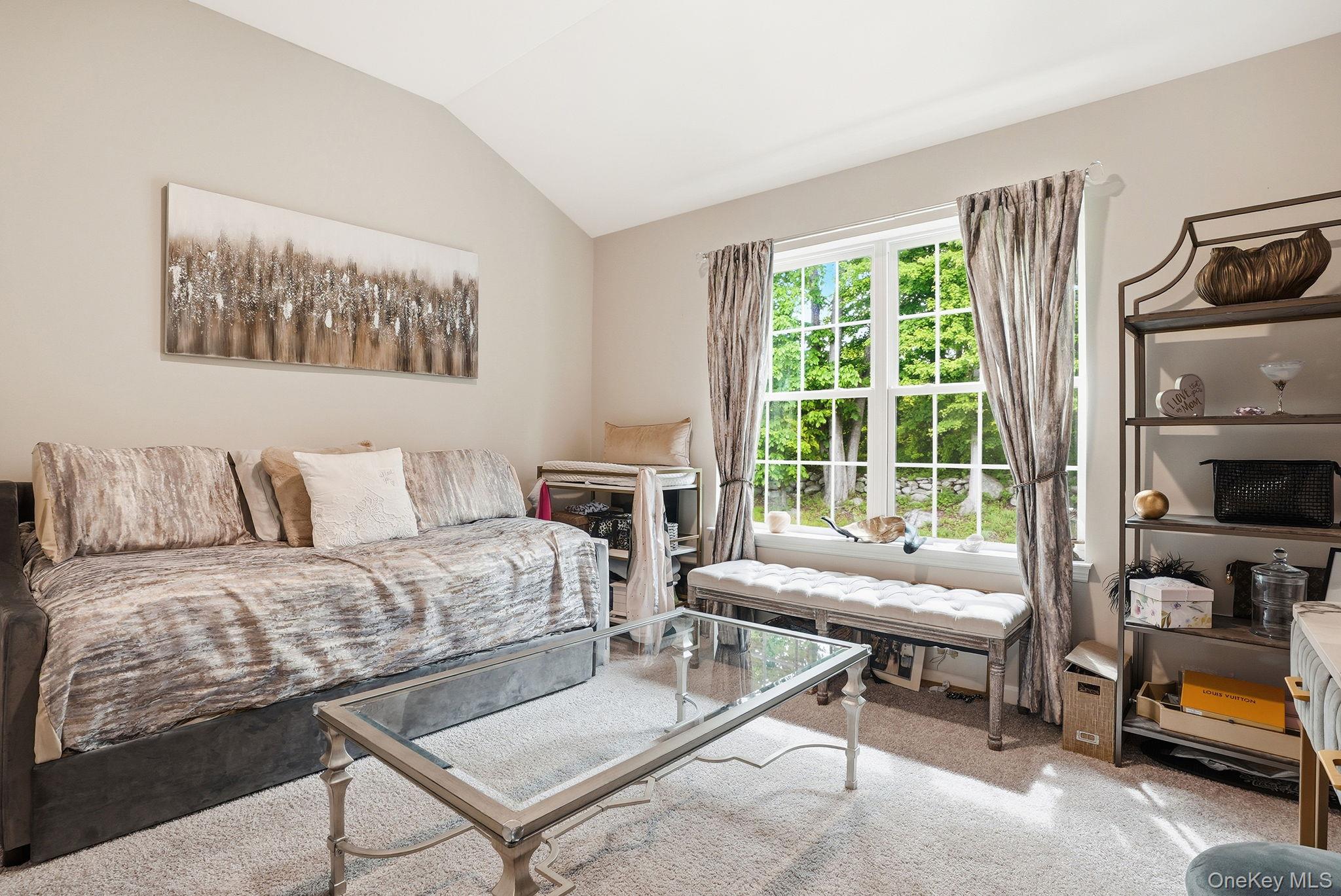 8 Muscoot River Road Granite Springs, NY 10527 - Photo 25 of 40 Second bedroom featuring vaulted ceiling room featuring a large multi-pane window, neutral-toned walls, and soft grey carpet flooring