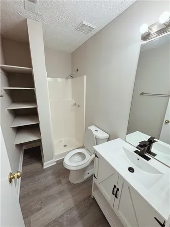 a bathroom with a sink toilet and shower