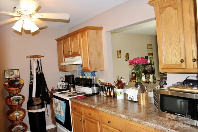 a kitchen with a stove a sink and a wooden cabinets