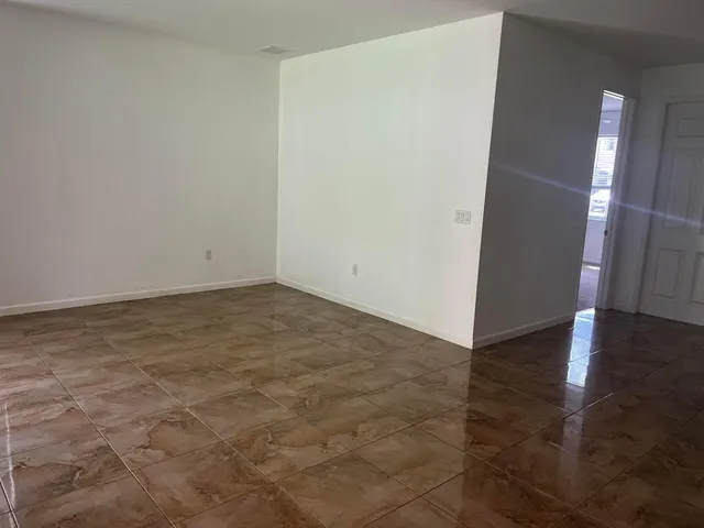 an empty room with wooden floor