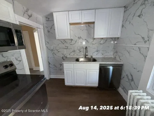 a kitchen with a sink a stove and cabinets