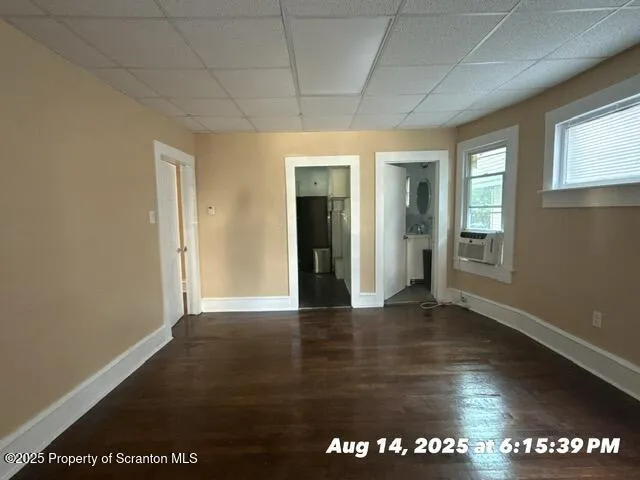 a view of an empty room with glass door