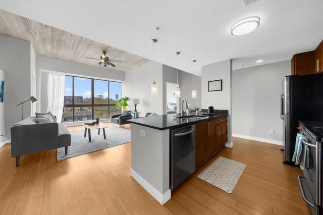 a kitchen with stainless steel appliances granite countertop a stove and a refrigerator