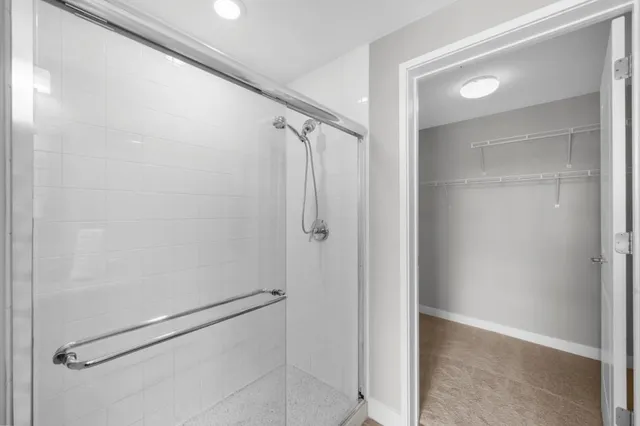 a bathroom with a glass shower door