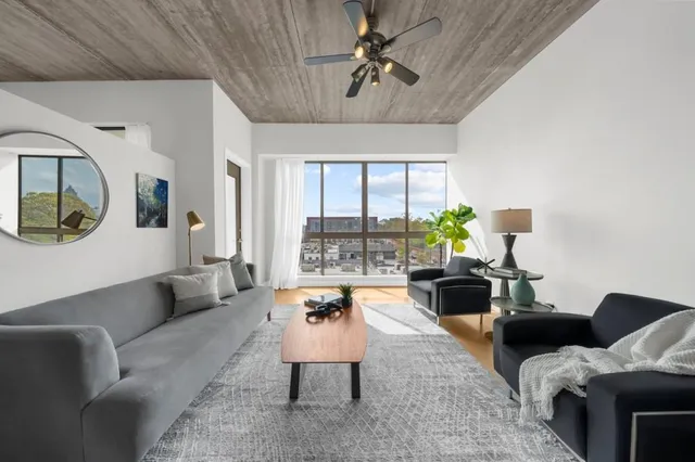 a living room with furniture and a large window