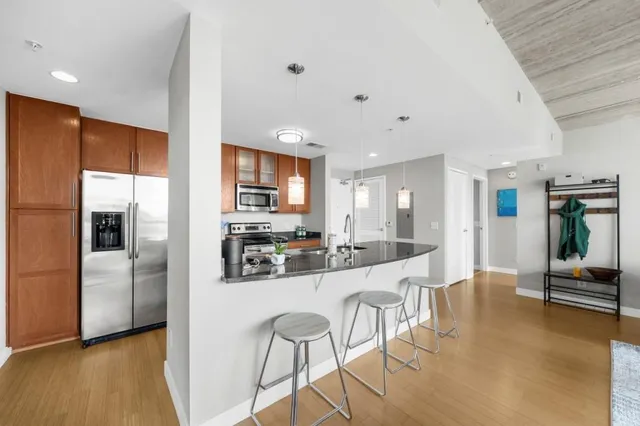 a large kitchen with a large counter top appliances and cabinets