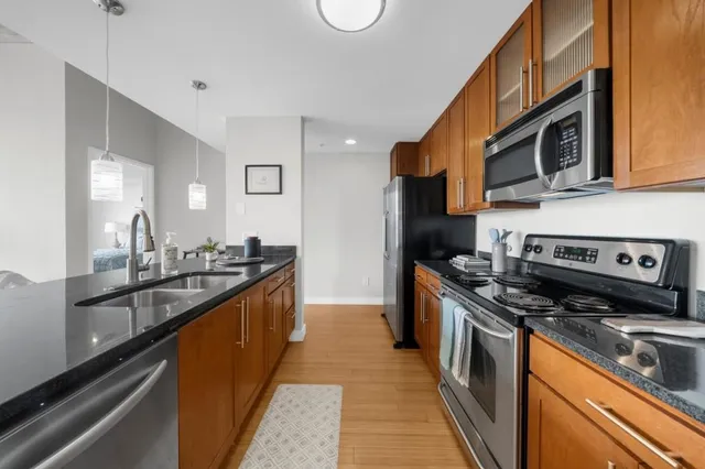 a kitchen with stainless steel appliances granite countertop a stove and a sink