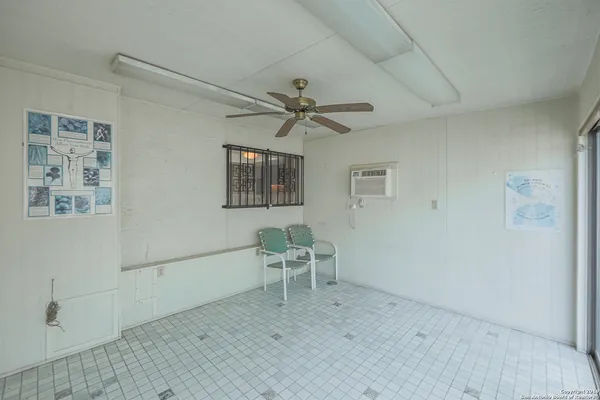 a view of an empty room and window ceiling fan