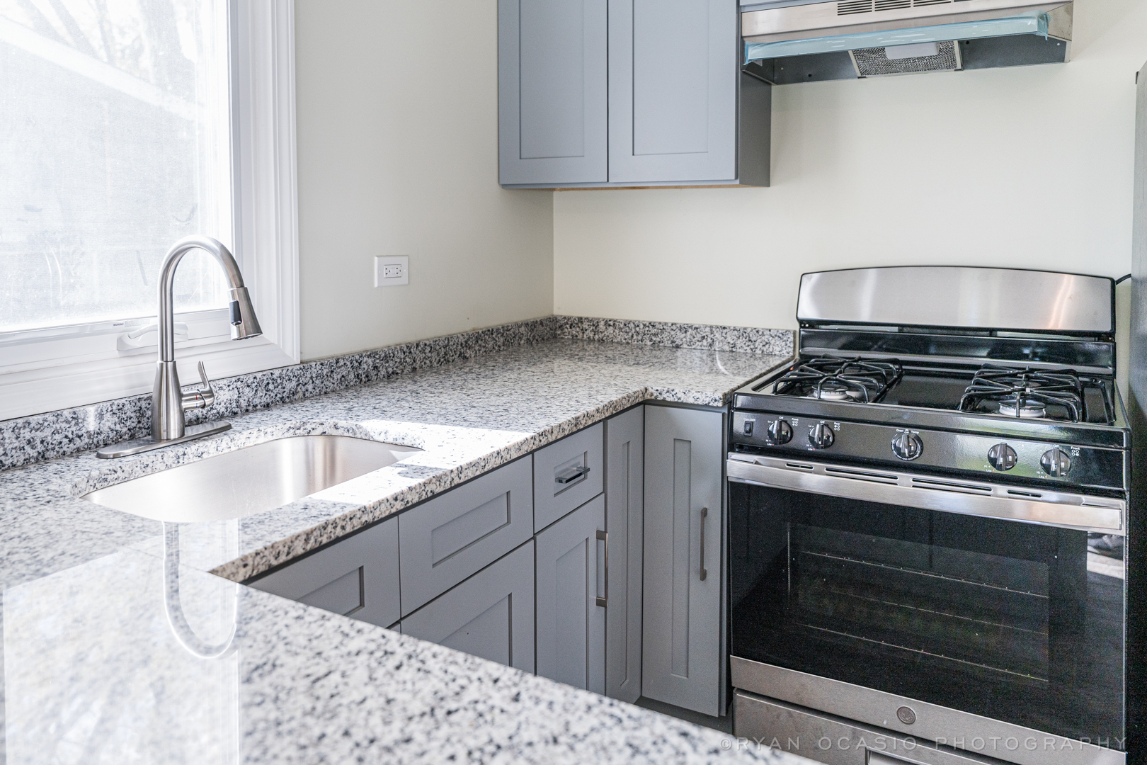 15318 Birch Road Markham, IL 60428 - Photo 11 of 26 a kitchen with granite countertop a stove and a sink