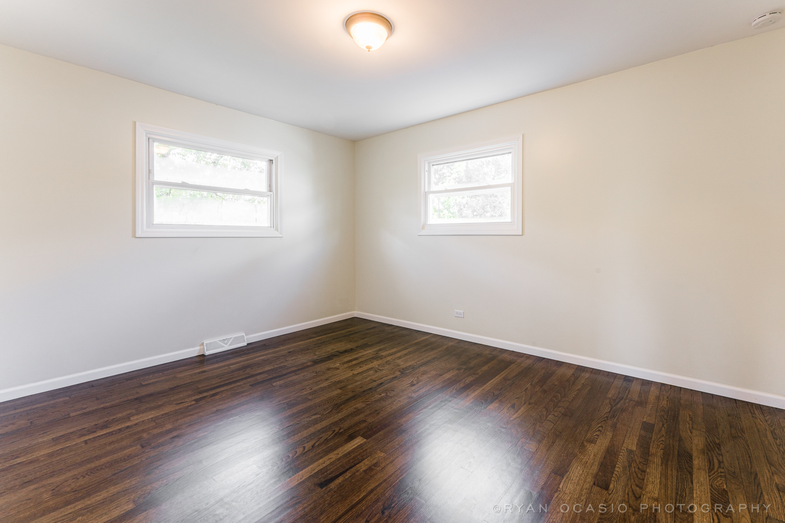 15318 Birch Road Markham, IL 60428 - Photo 13 of 26 a view of an empty room with wooden floor and a window