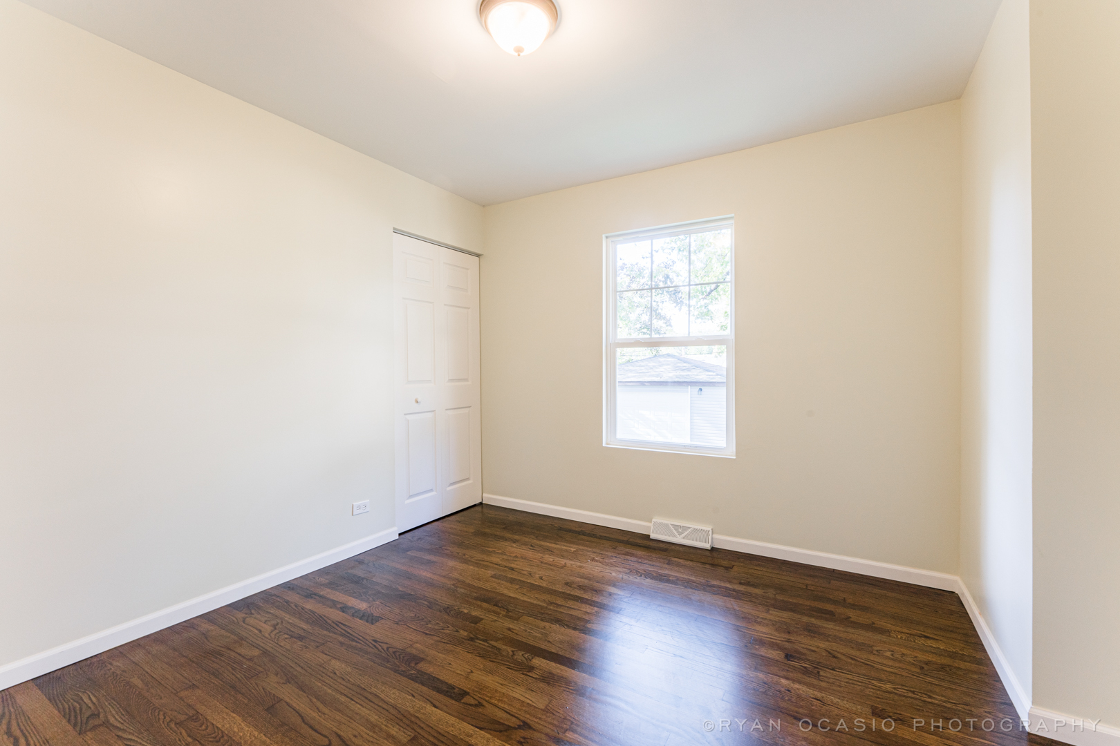 15318 Birch Road Markham, IL 60428 - Photo 15 of 26 an empty room with wooden floor and windows