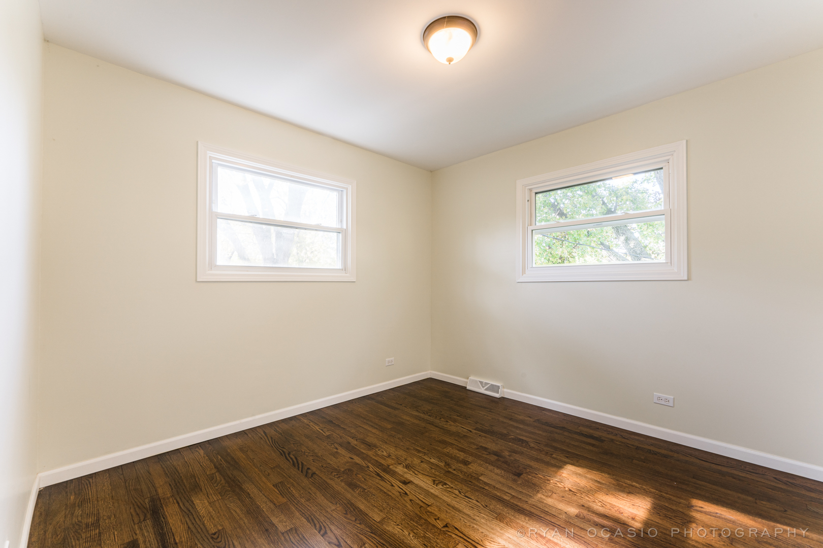15318 Birch Road Markham, IL 60428 - Photo 16 of 26 an empty room with wooden floor and windows