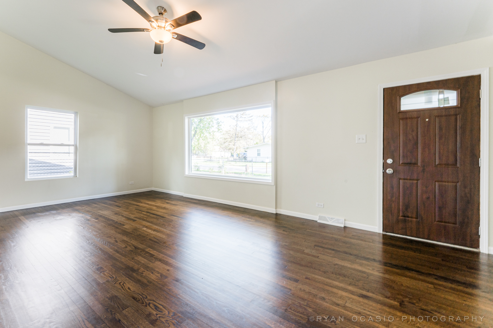 15318 Birch Road Markham, IL 60428 - Photo 5 of 26 a view of an empty room with wooden floor and a window