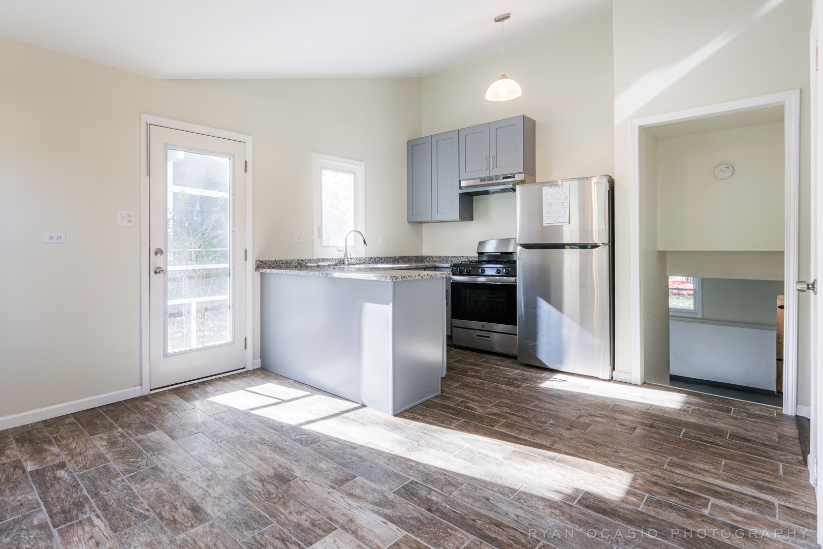 15318 Birch Road Markham, IL 60428 - Photo 8 of 26 a kitchen with granite countertop a refrigerator and a stove top oven