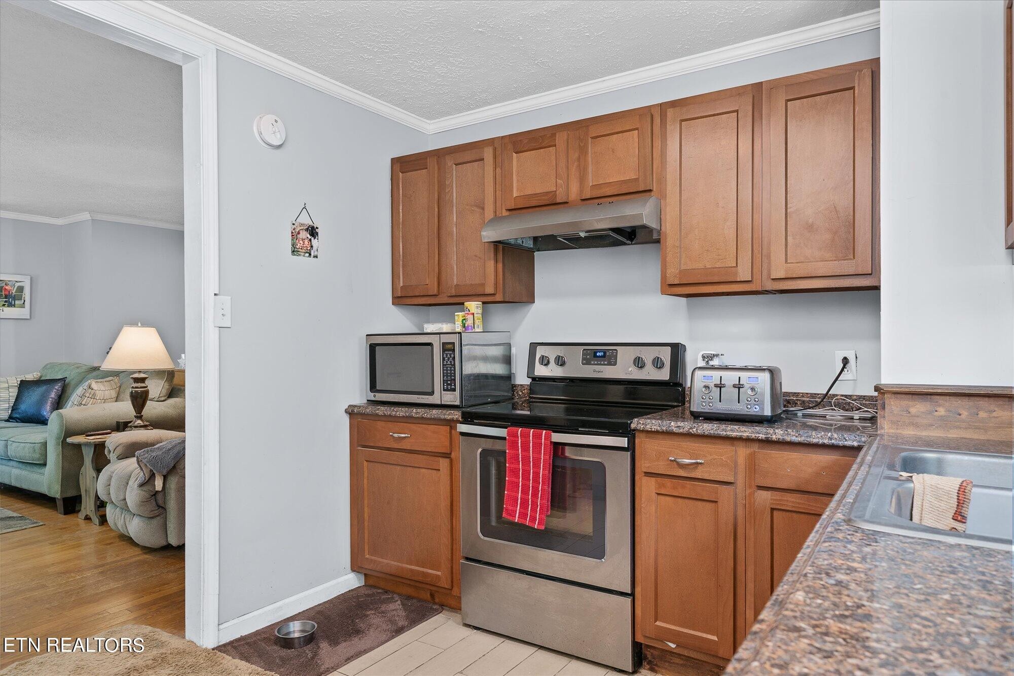 876 Shady Grove Road Lancing, TN 37770 - Photo 9 of 23 a kitchen with stainless steel appliances granite countertop a stove and a sink