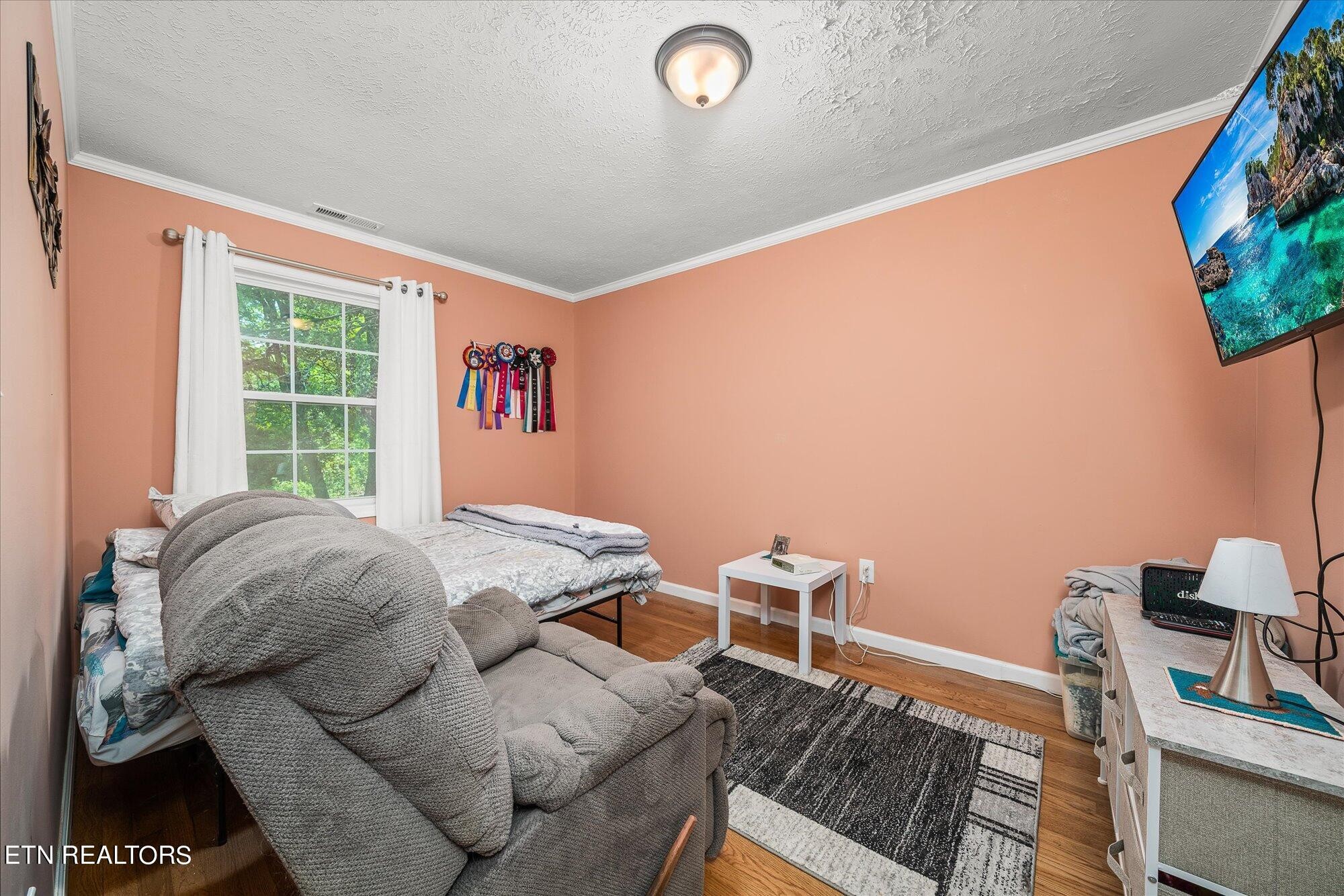 876 Shady Grove Road Lancing, TN 37770 - Photo 10 of 23 a bed sitting in a bedroom next to a window