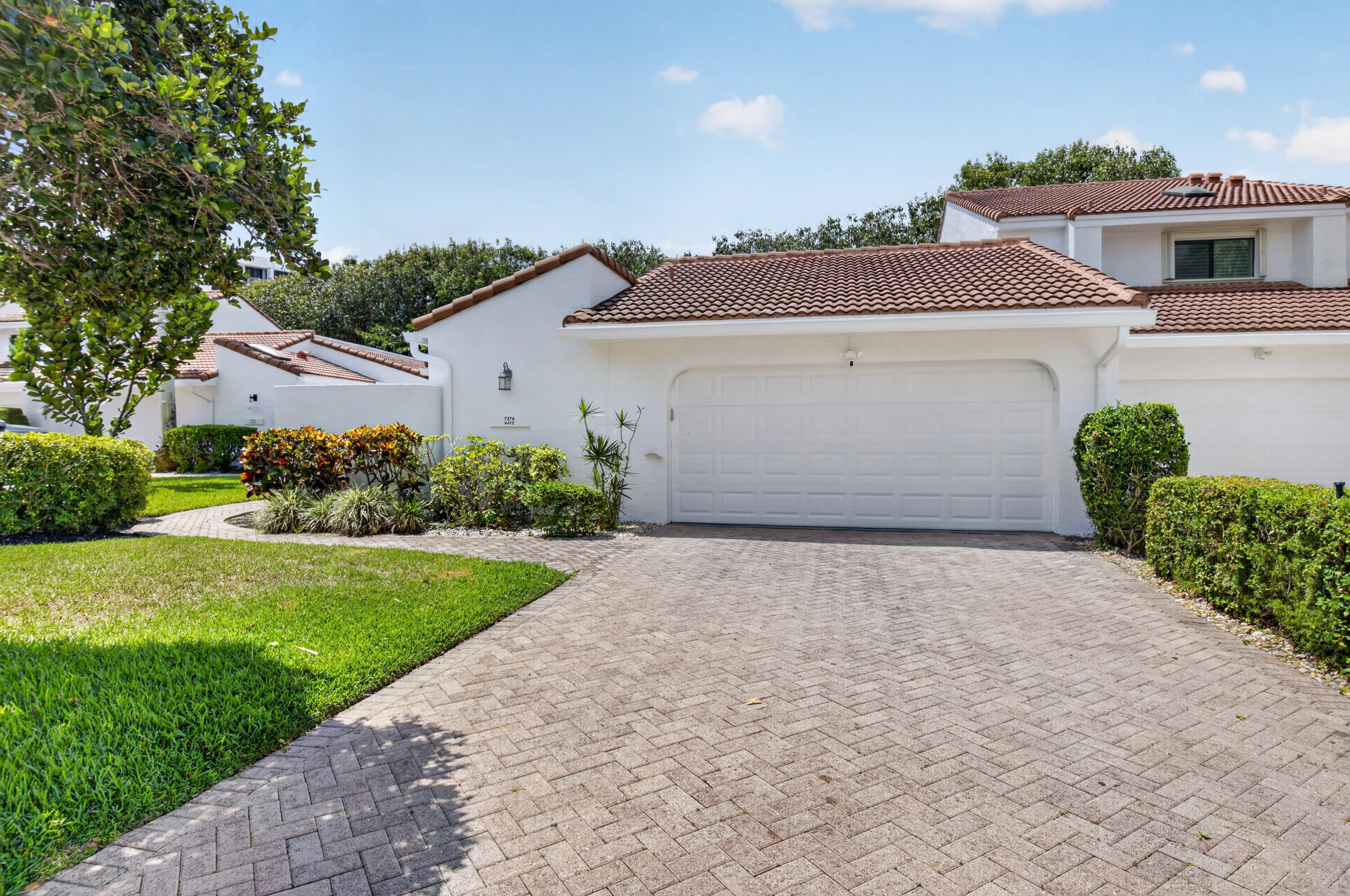 7374 Woodmont Court Boca Raton, FL 33434 - Photo 1 of 95 front view of a house with a yard