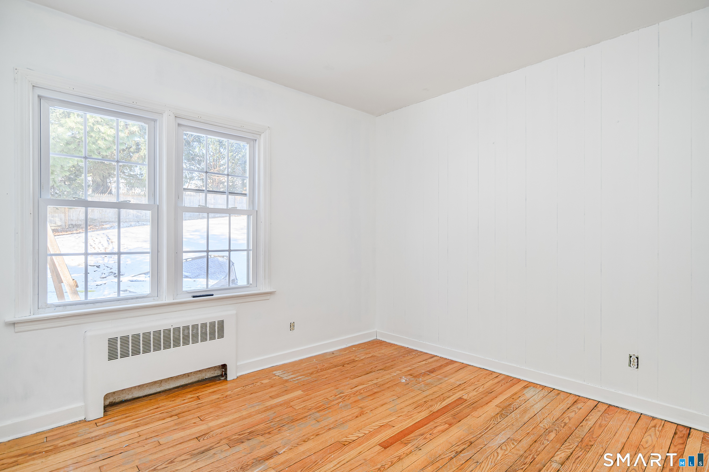 8 1st St Extension Danbury, CT 06810 - Photo 12 of 23 an empty room with wooden floor and windows