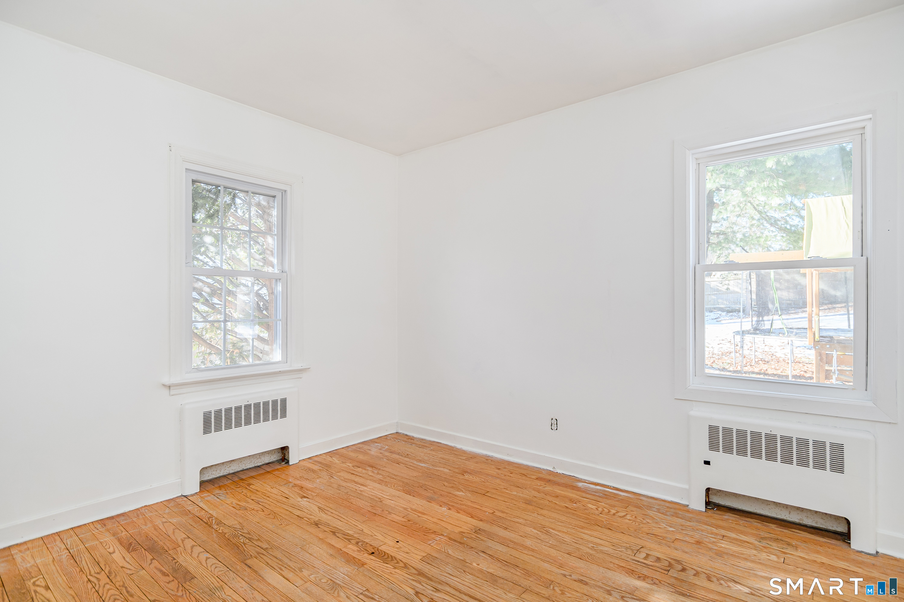 8 1st St Extension Danbury, CT 06810 - Photo 14 of 23 a view of an empty room with wooden floor and a window