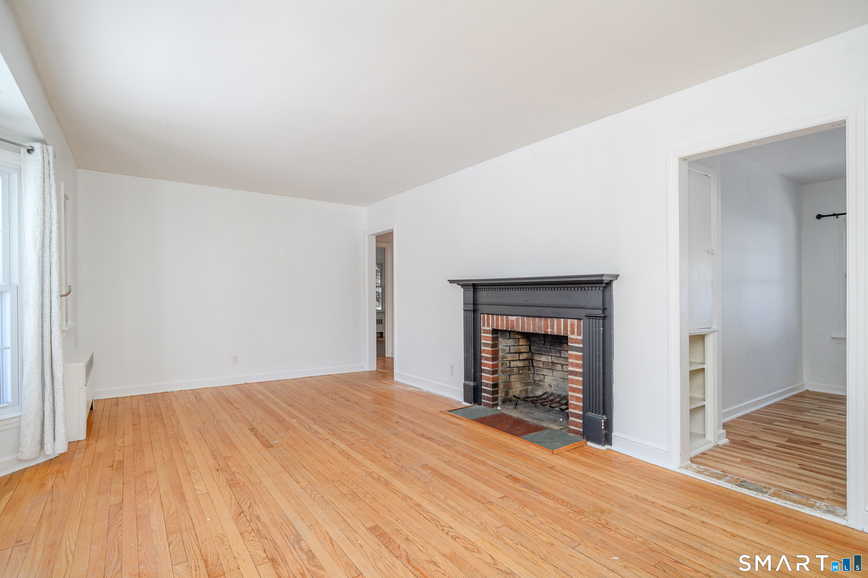 8 1st St Extension Danbury, CT 06810 - Photo 5 of 23 a bedroom with a bed and a fireplace