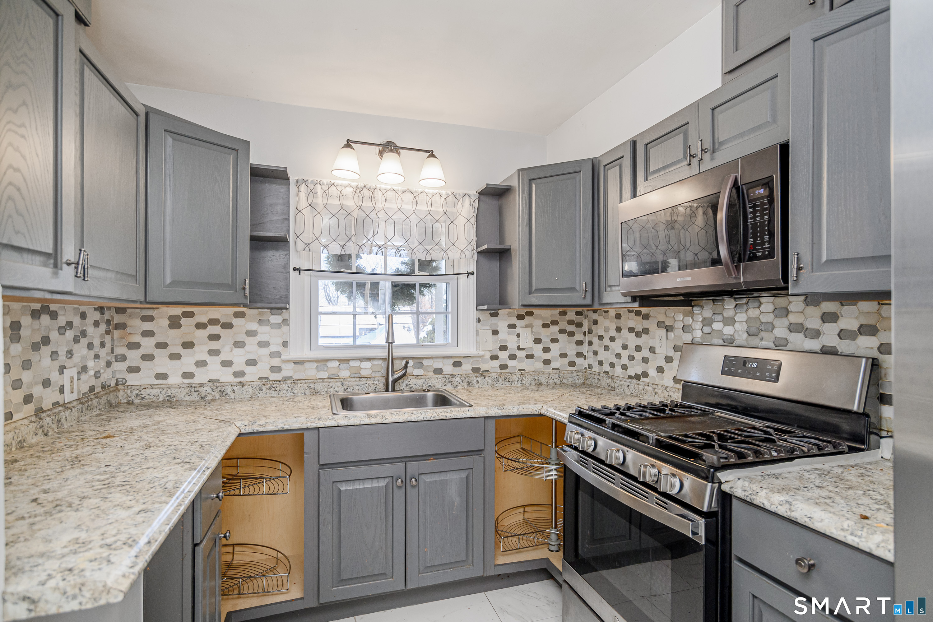 8 1st St Extension Danbury, CT 06810 - Photo 9 of 23 a kitchen with stainless steel appliances granite countertop a sink stove and cabinets