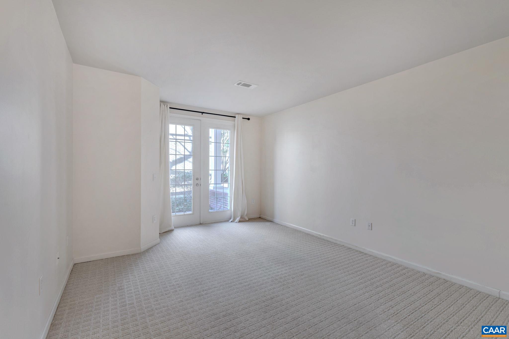 730 Walker Square, Unit 2D Charlottesville, VA 22903 - Photo 12 of 19 a view of an empty room with a window