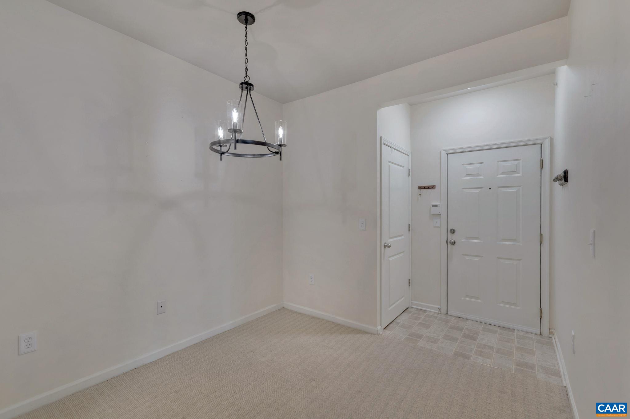 730 Walker Square, Unit 2D Charlottesville, VA 22903 - Photo 5 of 19 a view of an empty room and chandelier fan