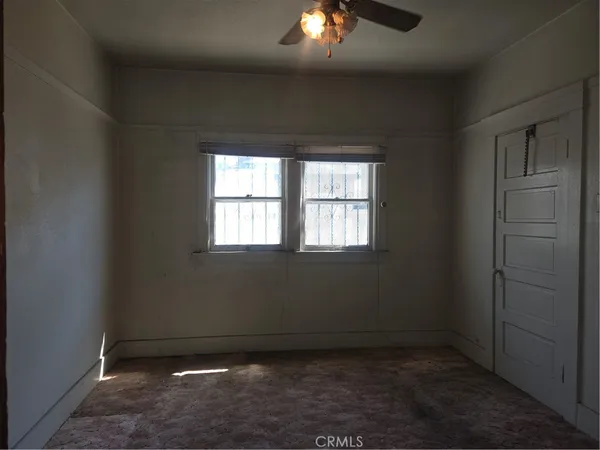 an empty room with closet and wooden floor