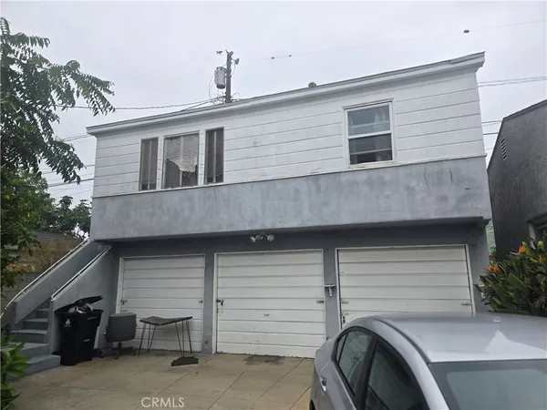 a front view of a house with parking space