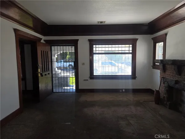 a view of empty room with floor to ceiling window