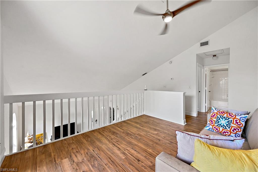938 Augusta Boulevard, Unit D937 Naples, FL 34113 - Photo 12 of 27 a view of a bedroom with wooden floor