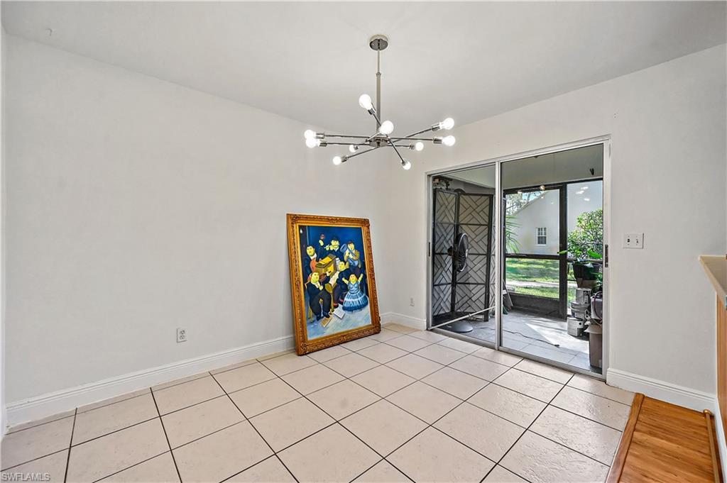 938 Augusta Boulevard, Unit D937 Naples, FL 34113 - Photo 13 of 27 an empty room with ceiling fan and window