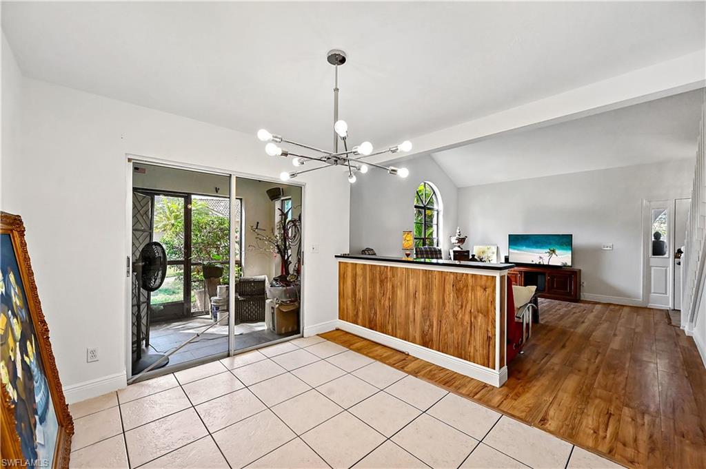 938 Augusta Boulevard, Unit D937 Naples, FL 34113 - Photo 14 of 27 a view of a livingroom with furniture cabinet wooden floor and a rug