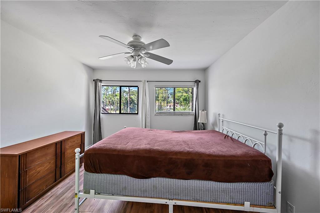938 Augusta Boulevard, Unit D937 Naples, FL 34113 - Photo 25 of 27 a bedroom with a large bed and a window