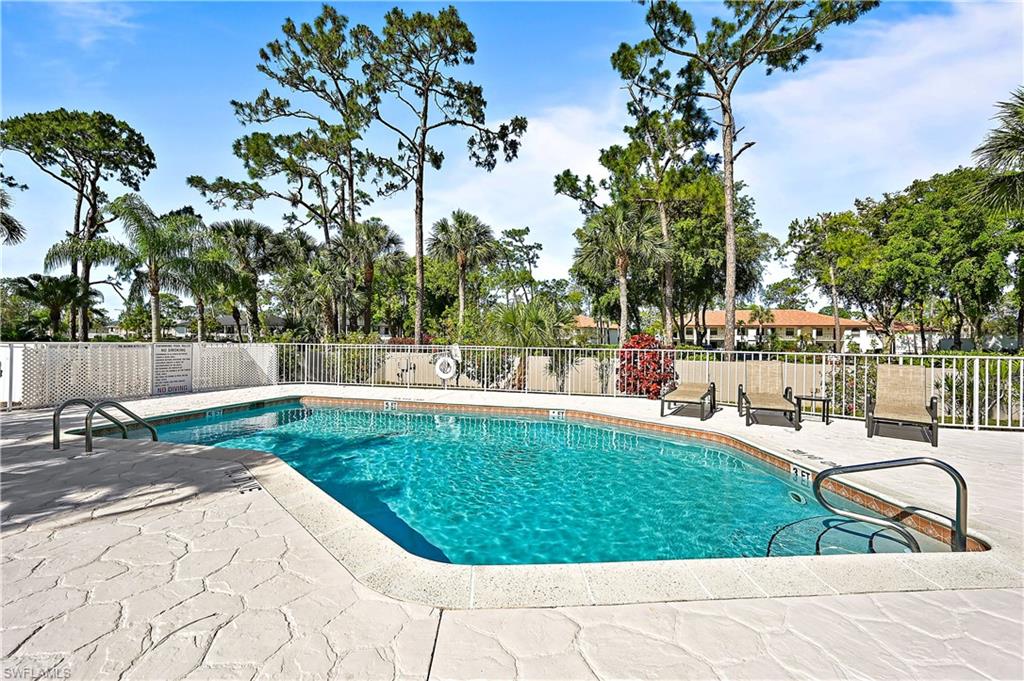 938 Augusta Boulevard, Unit D937 Naples, FL 34113 - Photo 26 of 27 a view of a swimming pool with a patio and garden